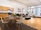 Thumbnail 1 of 37 - Downtown Los Angeles, CA Apartments For Rent - Living Room With Bamboo Wood Flooring, Floor-to-Ceiling Windows with Beautiful Natural Light, Kitchen, and Stainless Steel Kitchen Appliances