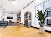 Thumbnail 9 of 37 - a living room with a large window and a potted plant