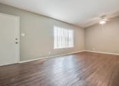 Thumbnail 16 of 17 - Living room and Dining area with ceiling fan, wood-style floors throughout