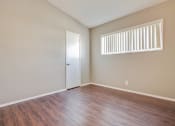 Thumbnail 13 of 17 - Bedroom with walk-in closet, vertical blinds, wood-inspired flooring