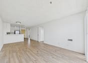Thumbnail 29 of 46 - A room with wooden flooring and white walls.