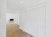 Thumbnail 108 of 135 - Closed white shutter doors in a room.