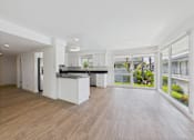 Thumbnail 104 of 135 - A modern kitchen with a bar area and a view of the outside.