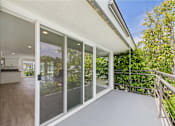 Thumbnail 112 of 135 - A sunny day in a modern house with a glass balcony.