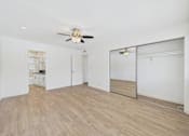 Thumbnail 115 of 135 - A room with a ceiling fan and wooden flooring.