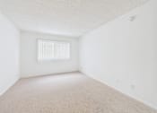 Thumbnail 22 of 88 - A room with a window and carpeted floor.