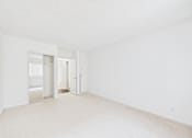 Thumbnail 23 of 88 - A white room with a doorway leading to another room.