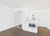 Thumbnail 33 of 88 - A kitchen with white cabinets and a microwave oven.