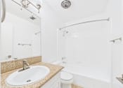 Thumbnail 31 of 88 - A bathroom with a sink, toilet, and bathtub.