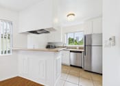 Thumbnail 26 of 88 - A kitchen with white cabinets and a stainless steel refrigerator.