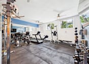 Thumbnail 70 of 77 - A gym with a variety of equipment including treadmills, weights, and exercise machines.