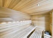 Thumbnail 74 of 77 - A wooden sauna with benches and a heater.