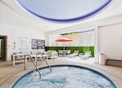 Thumbnail 72 of 77 - A round pool with a hot tub in the middle of it.