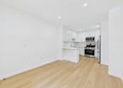 Thumbnail 18 of 28 - A kitchen with white cabinets and a microwave.