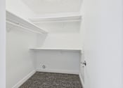Thumbnail 28 of 29 - A small, empty room with a carpeted floor and white walls.