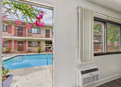 Thumbnail 27 of 29 - A white wall with a window and air conditioner unit.