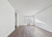 Thumbnail 15 of 36 - A room with wooden floors and white walls.