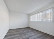 Thumbnail 10 of 36 - A room with a window covered by white blinds.