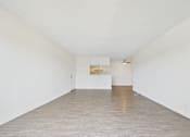Thumbnail 42 of 45 - A room with white walls and wooden flooring with a white box on the floor.
