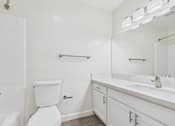Thumbnail 39 of 45 - A white toilet sits next to a white sink in a bathroom.