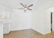 Thumbnail 38 of 45 - A room with a ceiling fan and wooden flooring.