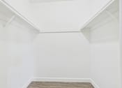 Thumbnail 41 of 45 - A white room with a wooden floor and white walls.