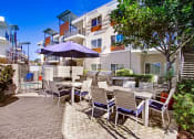 Thumbnail 19 of 22 - a patio with tables and chairs and umbrellas