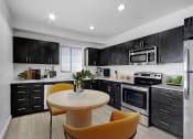Thumbnail 1 of 22 - a kitchen with black cabinets and white appliances