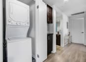 Thumbnail 3 of 22 - a white washer and dryer in a room with a bathroom and a kitchen