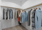 Thumbnail 8 of 22 - a closet with a rack of clothes and a door