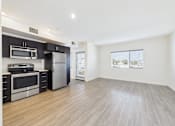 Thumbnail 19 of 33 - A kitchen with a stainless steel refrigerator and oven.
