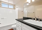Thumbnail 15 of 15 - a bathroom with a sink and a toilet and a bath tub