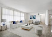 Thumbnail 6 of 49 - a living room with a white couch and a coffee table