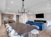 Thumbnail 2 of 75 - a large wooden table with white chairs and a blue couch in a room with white walls and