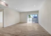 Thumbnail 57 of 75 - a bedroom with hardwood floors and white walls