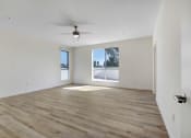 Thumbnail 62 of 75 - an empty living room with a large window and a ceiling fan