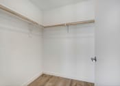 Thumbnail 61 of 75 - an empty room with white walls and a wooden floor