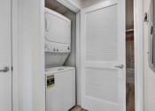 Thumbnail 60 of 75 - a small laundry room with a washer and dryer