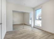 Thumbnail 64 of 75 - a bedroom with hardwood floors and white walls