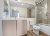 Thumbnail 65 of 75 - a bathroom with a toilet sink and mirror
