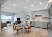 Thumbnail 10 of 75 - a kitchen and dining area in a 555 waverly unit