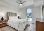 Thumbnail 13 of 75 - a bedroom with a bed and a ceiling fan