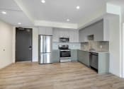 Thumbnail 21 of 75 - a kitchen with gray cabinets and stainless steel appliances