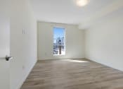 Thumbnail 26 of 75 - a bedroom with hardwood floors and white walls