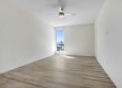 Thumbnail 28 of 75 - a bedroom with hardwood floors and white walls