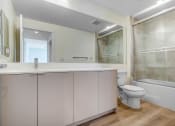 Thumbnail 30 of 75 - a bathroom with a toilet sink mirror and bathtub