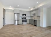 Thumbnail 68 of 75 - a kitchen with stainless steel appliances and a wooden floor