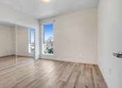 Thumbnail 73 of 75 - a bedroom with hardwood floors and white walls