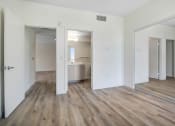 Thumbnail 71 of 75 - a bedroom with hardwood floors and white walls