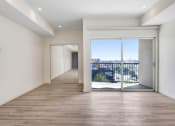 Thumbnail 17 of 75 - a bedroom with a medium sized window and a door that leads to a balcony